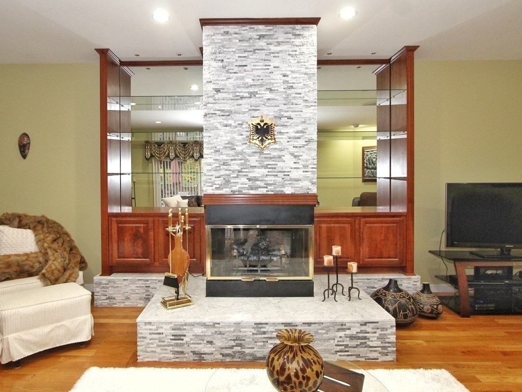 44 Whisper Drive Worcester, MA 01609 - Photo 12 of 40 a living room with furniture a flat screen tv and a fireplace