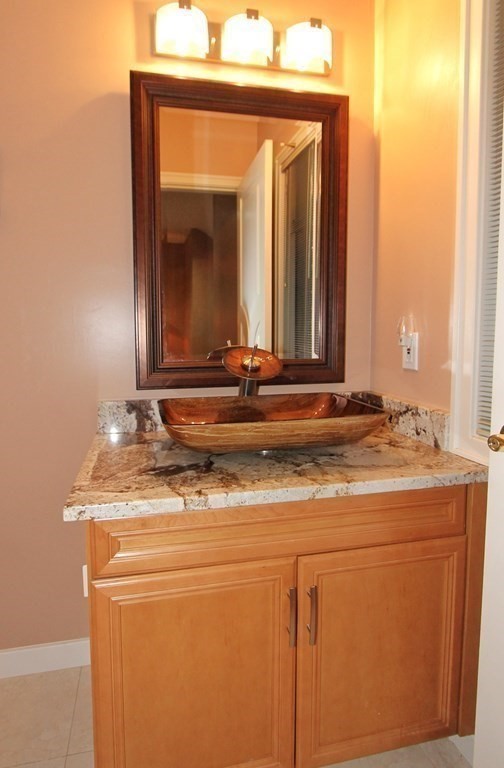 44 Whisper Drive Worcester, MA 01609 - Photo 15 of 40 a bathroom with a granite countertop sink and a mirror