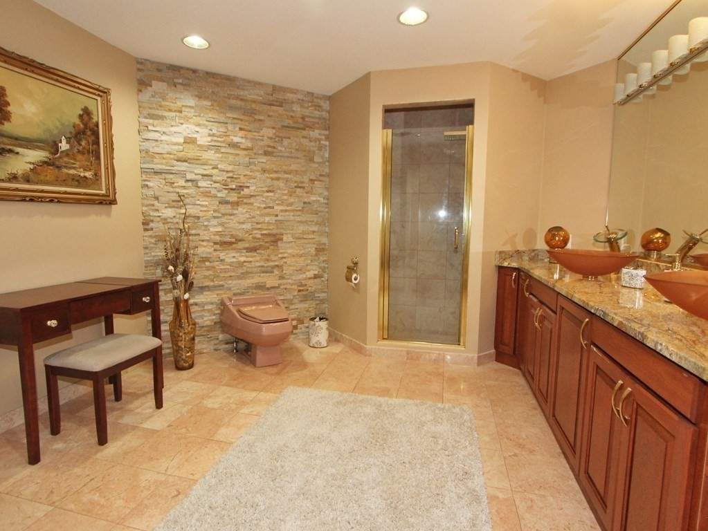 44 Whisper Drive Worcester, MA 01609 - Photo 20 of 40 a bathroom with a granite countertop sink a toilet a mirror and shower