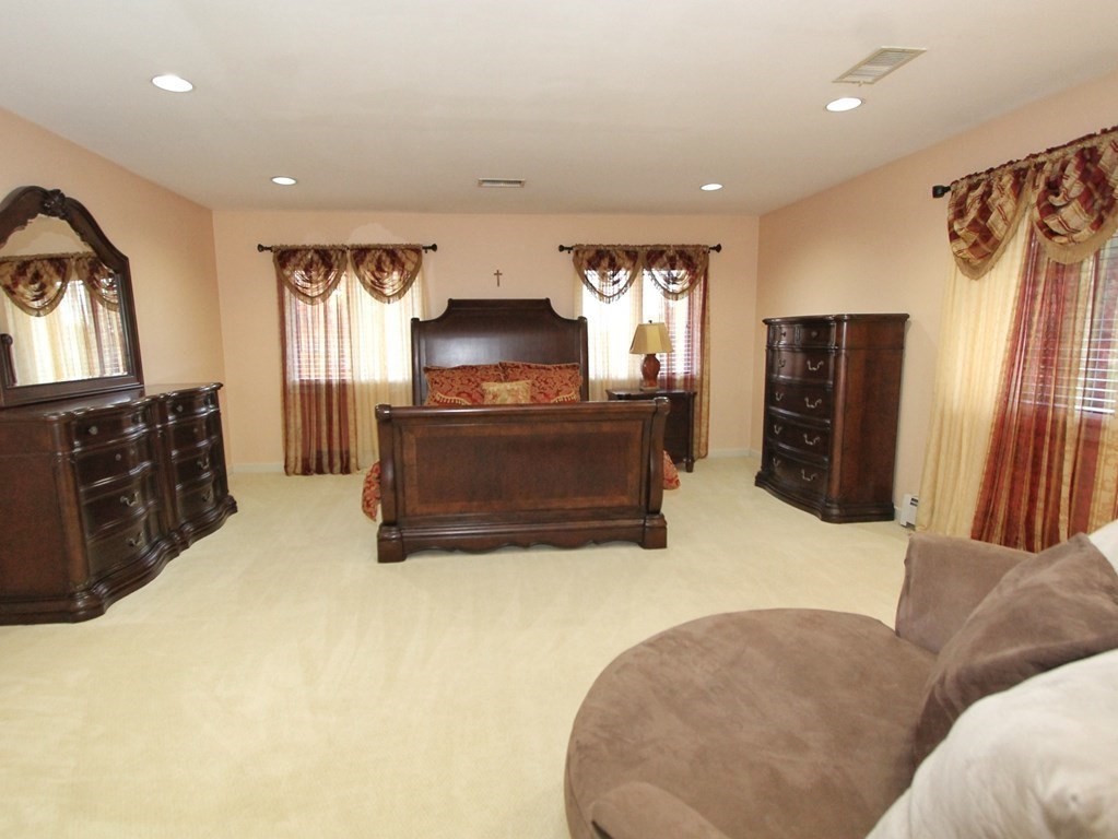 44 Whisper Drive Worcester, MA 01609 - Photo 27 of 40 a living room with furniture a flat screen tv and a fireplace