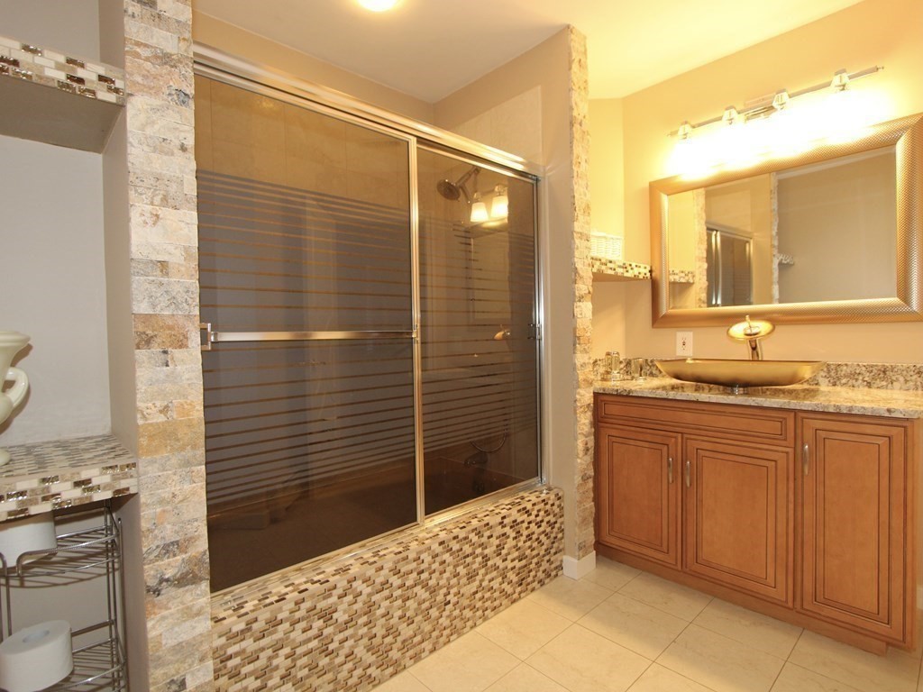 44 Whisper Drive Worcester, MA 01609 - Photo 28 of 40 a bathroom with a granite countertop sink a toilet and shower