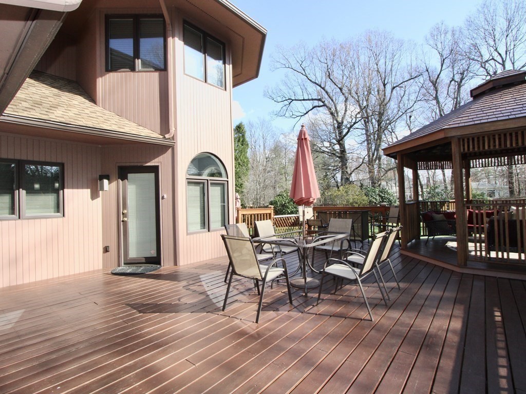 44 Whisper Drive Worcester, MA 01609 - Photo 30 of 40 a view of a patio with table and chairs and wooden floor