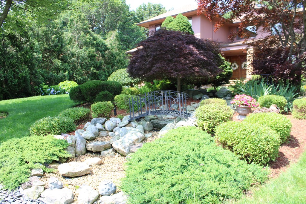 44 Whisper Drive Worcester, MA 01609 - Photo 37 of 40 a view of a backyard with plants and flowers