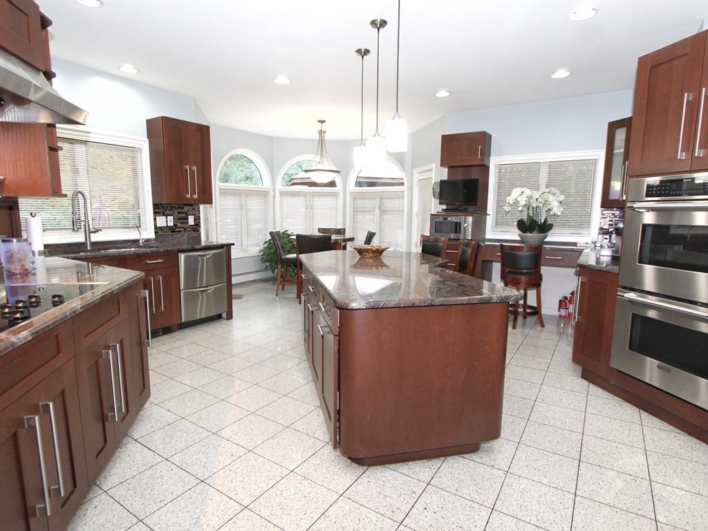 44 Whisper Drive Worcester, MA 01609 - Photo 7 of 40 a kitchen with stainless steel appliances granite countertop a stove top oven a sink and a refrigerator