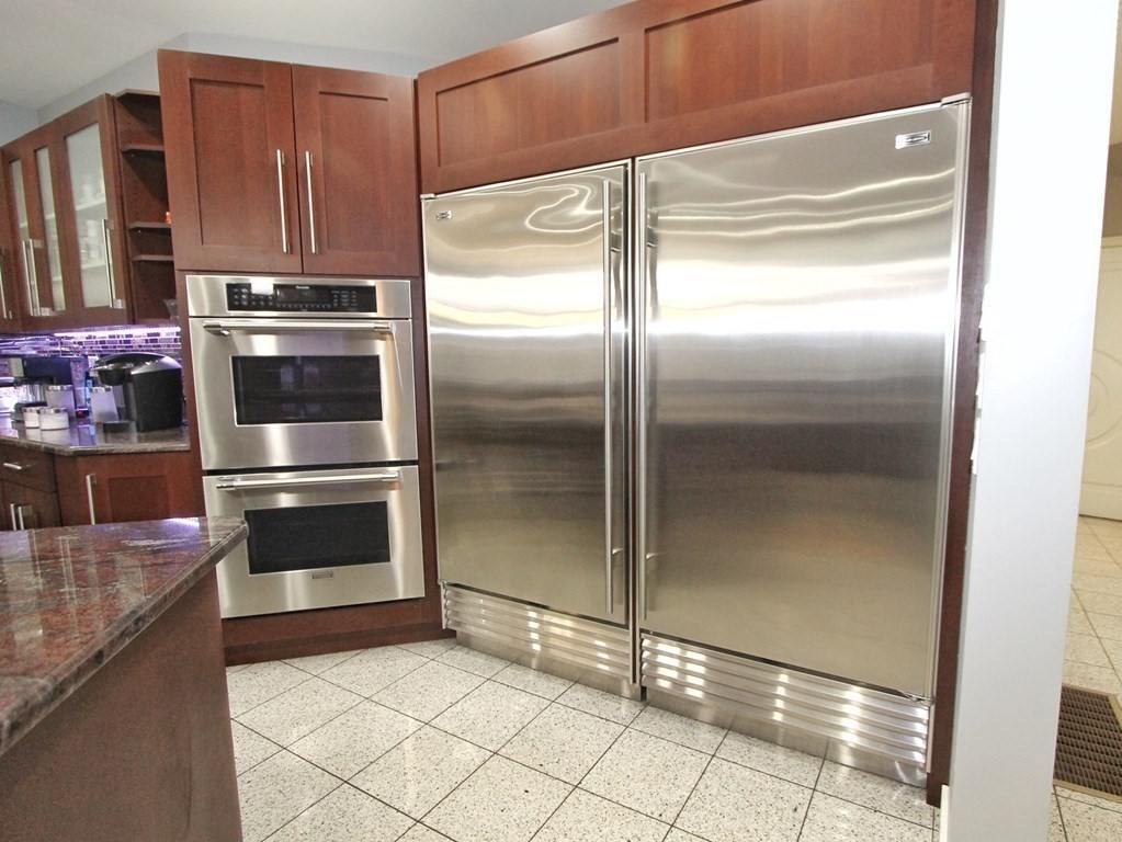 44 Whisper Drive Worcester, MA 01609 - Photo 8 of 40 a kitchen with granite countertop a refrigerator and a stove
