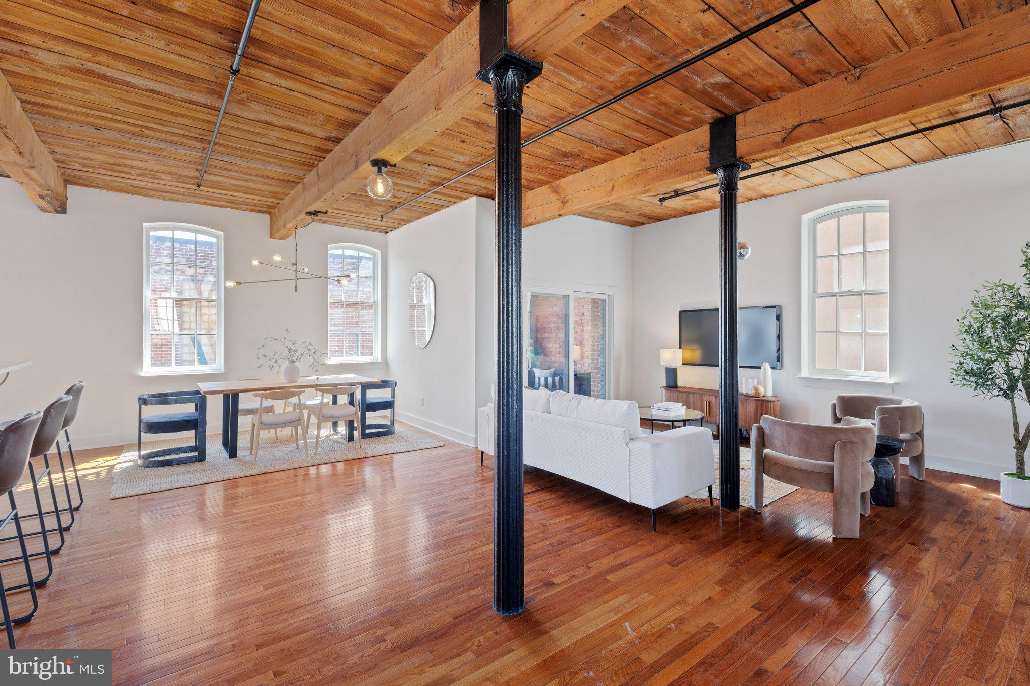 a living room with furniture and wooden floor