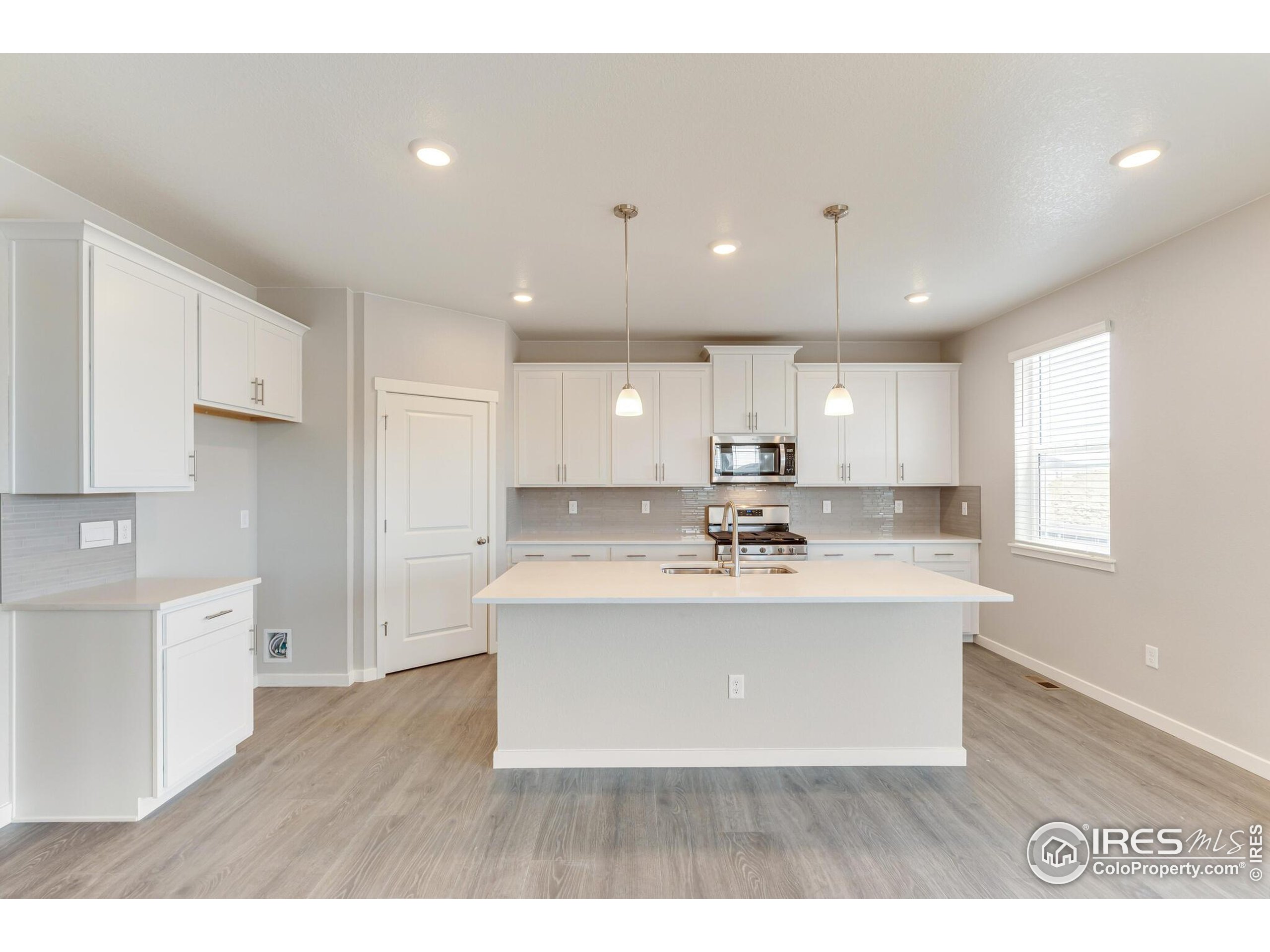 1894 Chaffee Crest Drive Berthoud, CO 80513 - Photo 11 of 31 a view of kitchen with kitchen island stainless steel appliances sink and stove