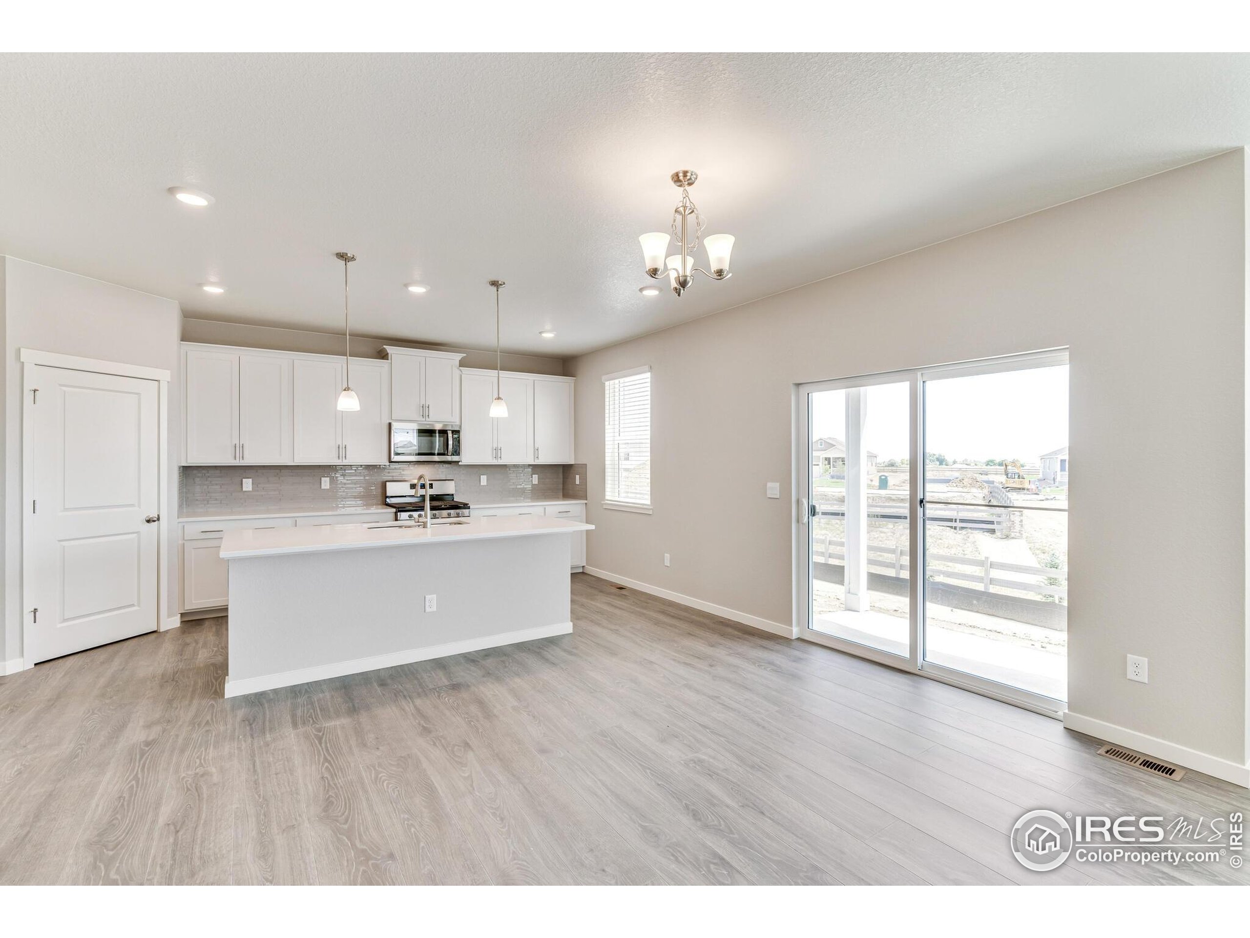 1894 Chaffee Crest Drive Berthoud, CO 80513 - Photo 13 of 31 a view of a kitchen with wooden floor