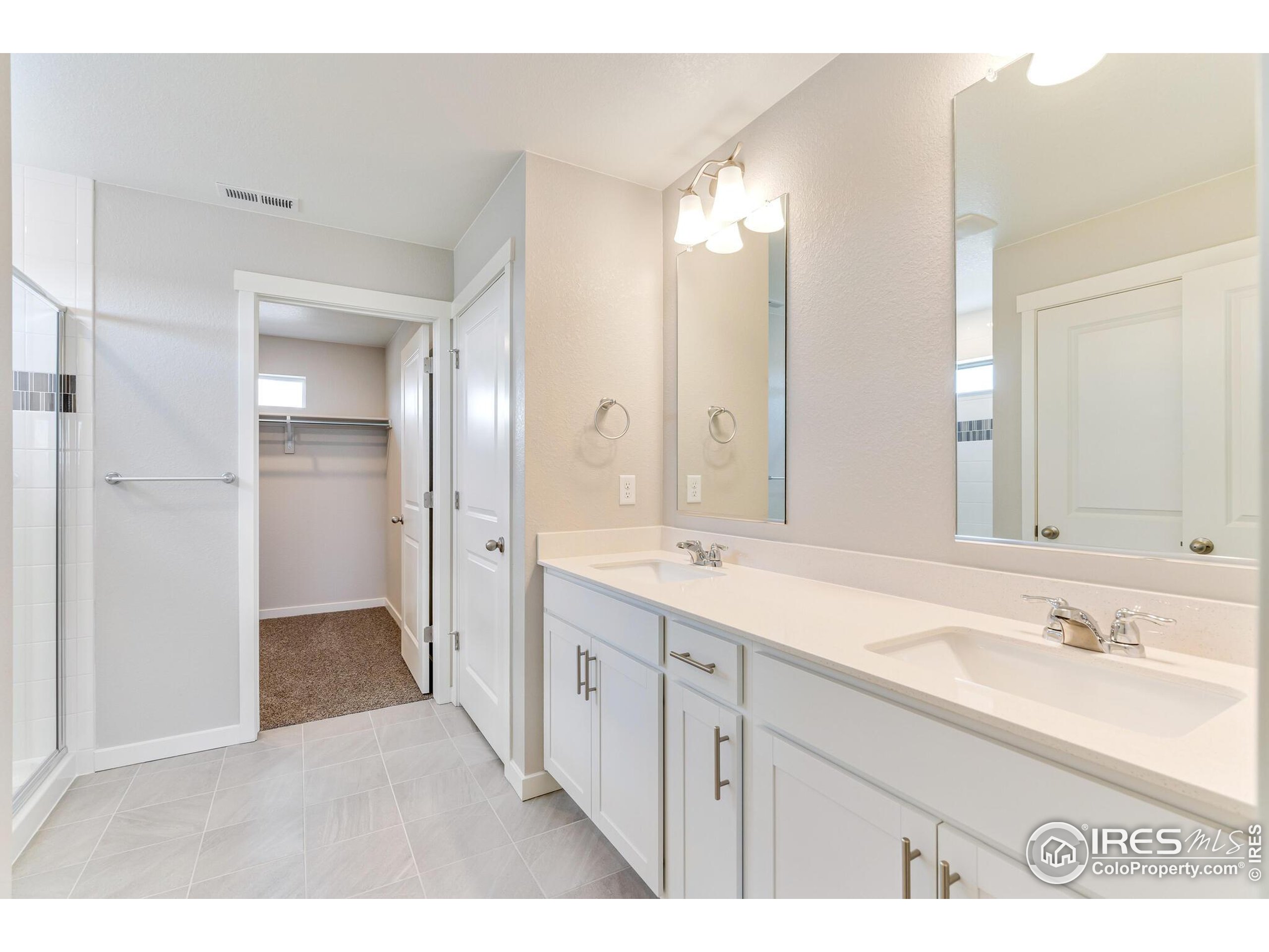 1894 Chaffee Crest Drive Berthoud, CO 80513 - Photo 17 of 31 a bathroom with a double vanity sink mirror and double