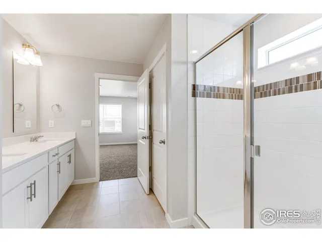 a bathroom with a double vanity sink and mirror