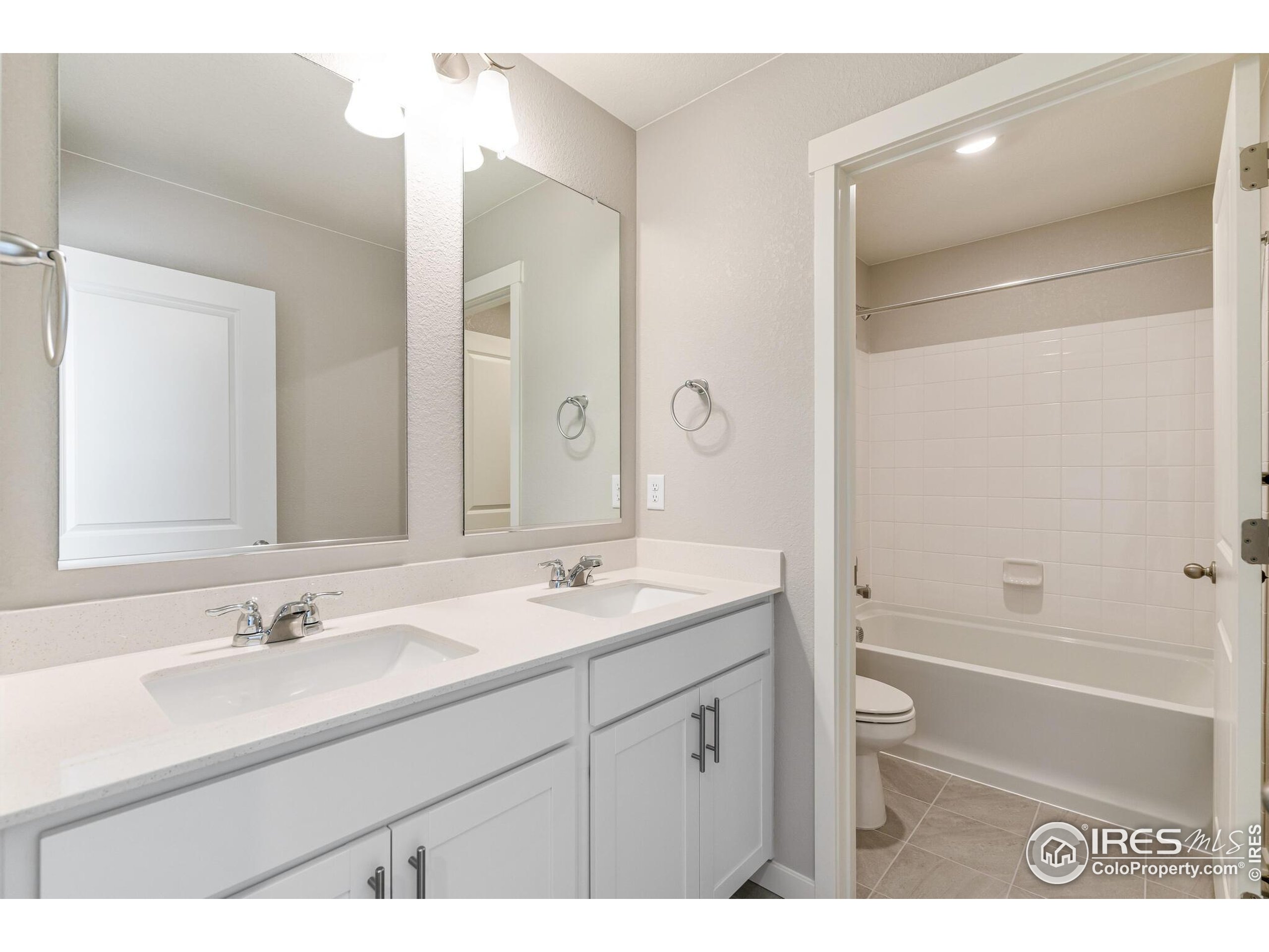 1894 Chaffee Crest Drive Berthoud, CO 80513 - Photo 21 of 31 a bathroom with a sink double vanity granite tub shower and a mirror