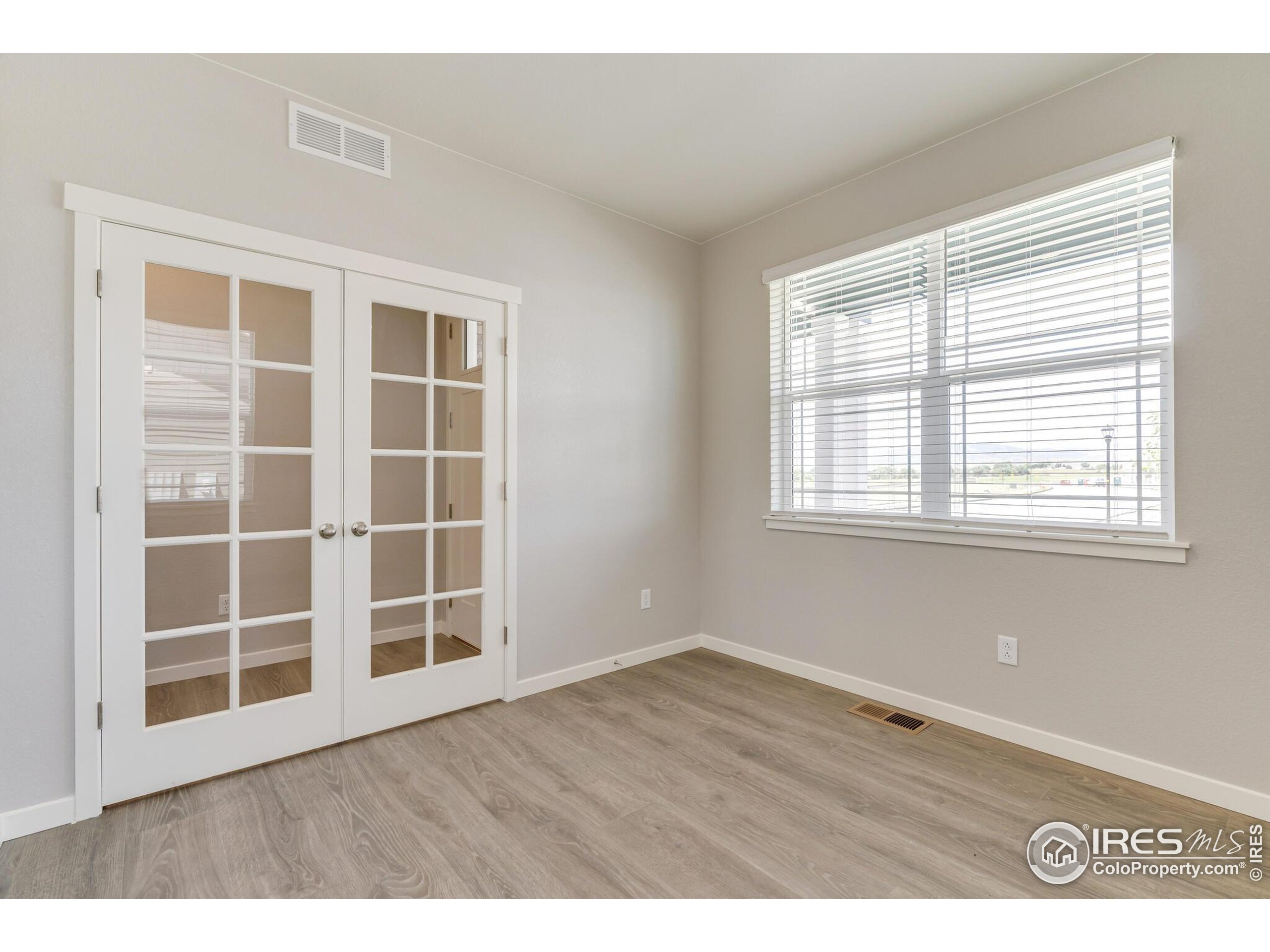 1894 Chaffee Crest Drive Berthoud, CO 80513 - Photo 5 of 31 an empty room with wooden floor and windows