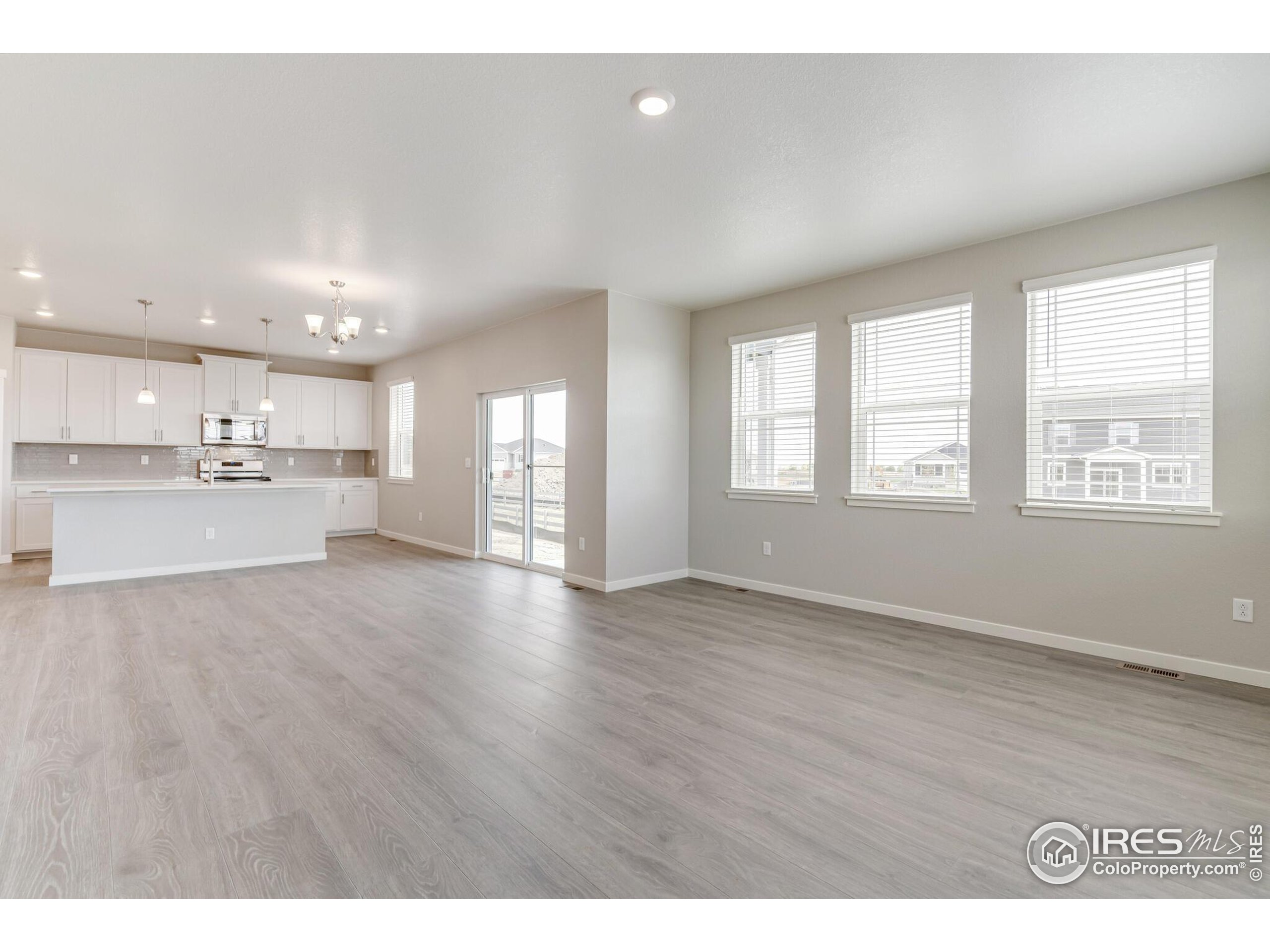 1894 Chaffee Crest Drive Berthoud, CO 80513 - Photo 7 of 31 a view of an empty room with wooden floor and a window
