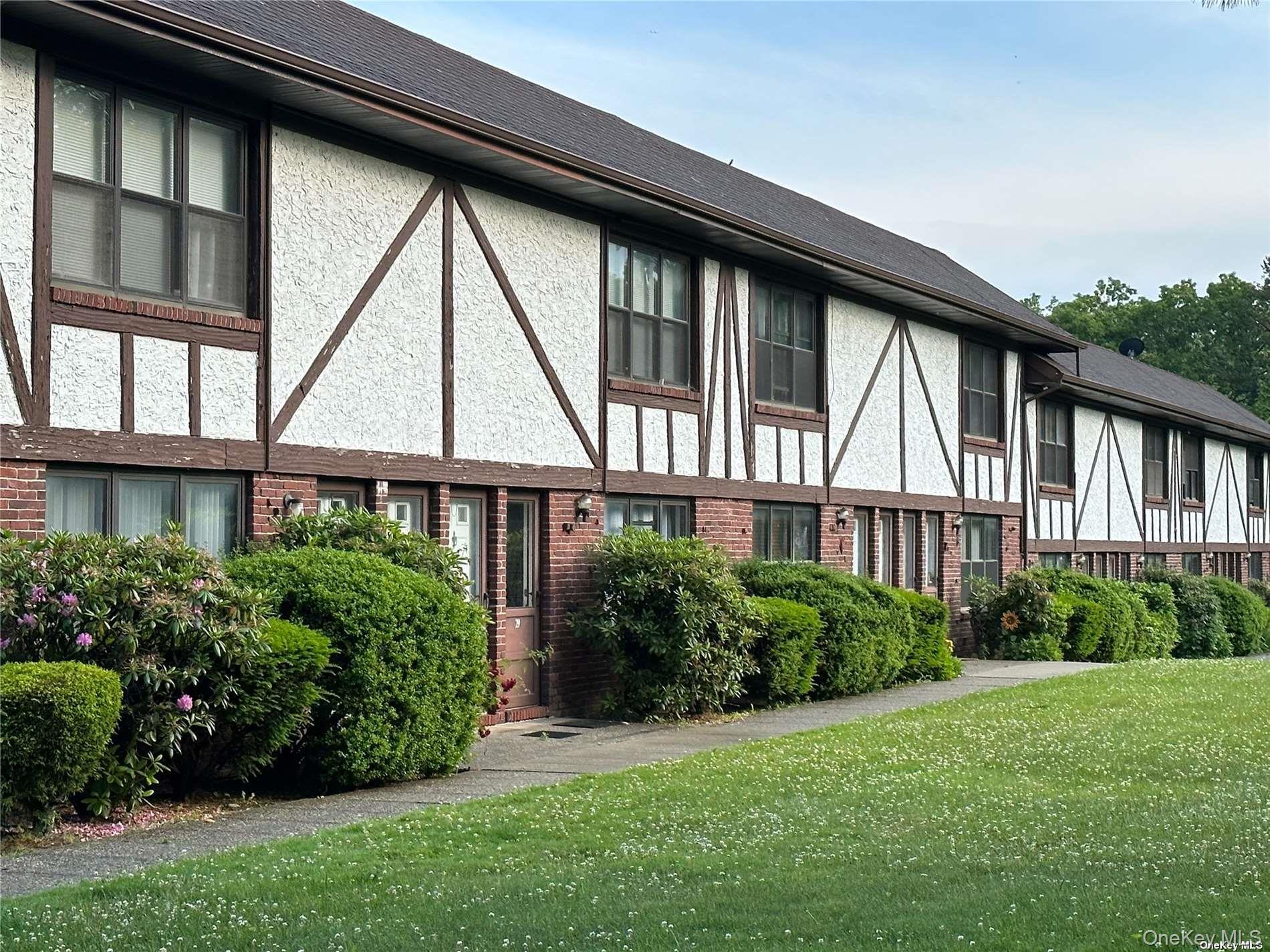 26 Bailey Court, Unit 26 Middle Island, NY 11953 - Photo 1 of 16 a view of a backyard with plants and large trees