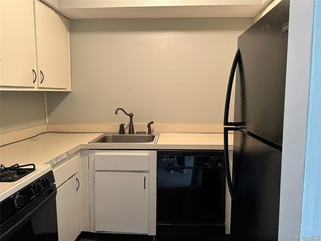 a kitchen with a sink and a refrigerator