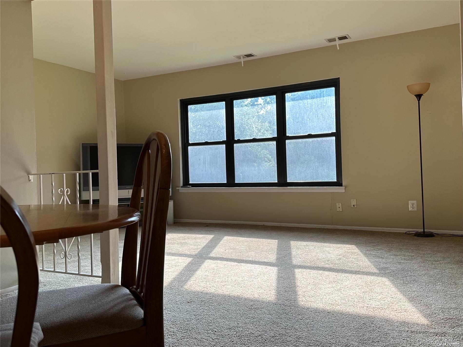 26 Bailey Court, Unit 26 Middle Island, NY 11953 - Photo 4 of 16 a view of an empty room with balcony and furniture