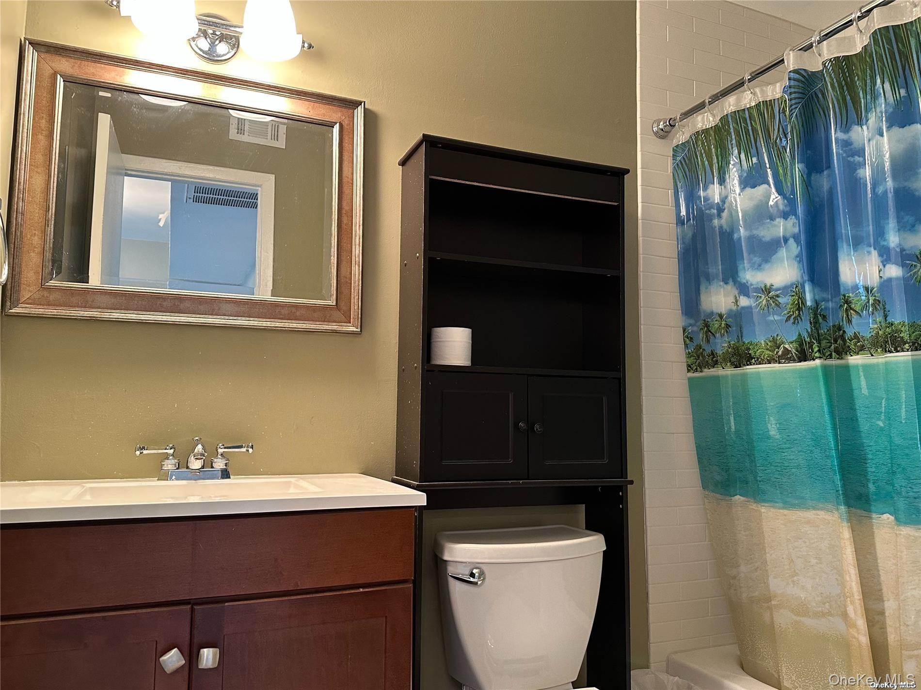 26 Bailey Court, Unit 26 Middle Island, NY 11953 - Photo 5 of 16 a bathroom with a toilet a sink and mirror