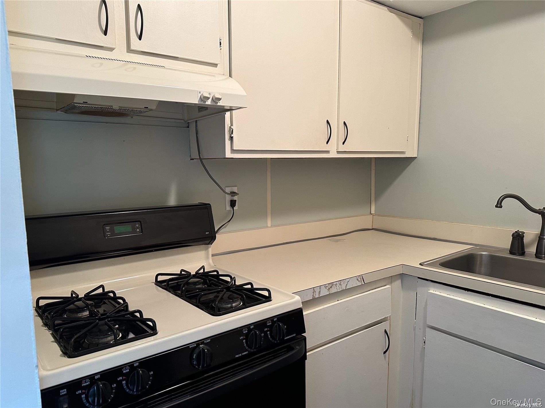 26 Bailey Court, Unit 26 Middle Island, NY 11953 - Photo 6 of 16 a kitchen with a stove and a sink