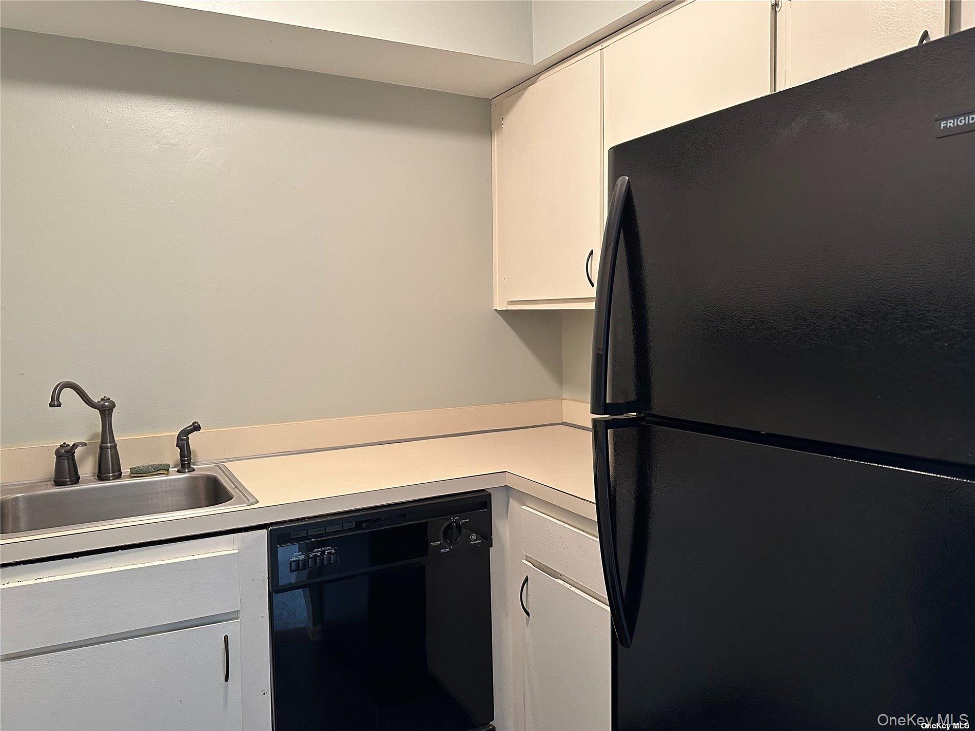 26 Bailey Court, Unit 26 Middle Island, NY 11953 - Photo 7 of 16 a kitchen with a refrigerator and cabinets