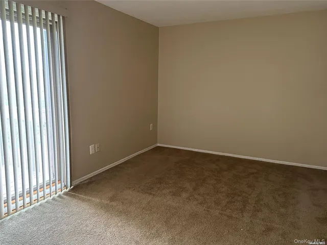 an empty room with a empty space and windows