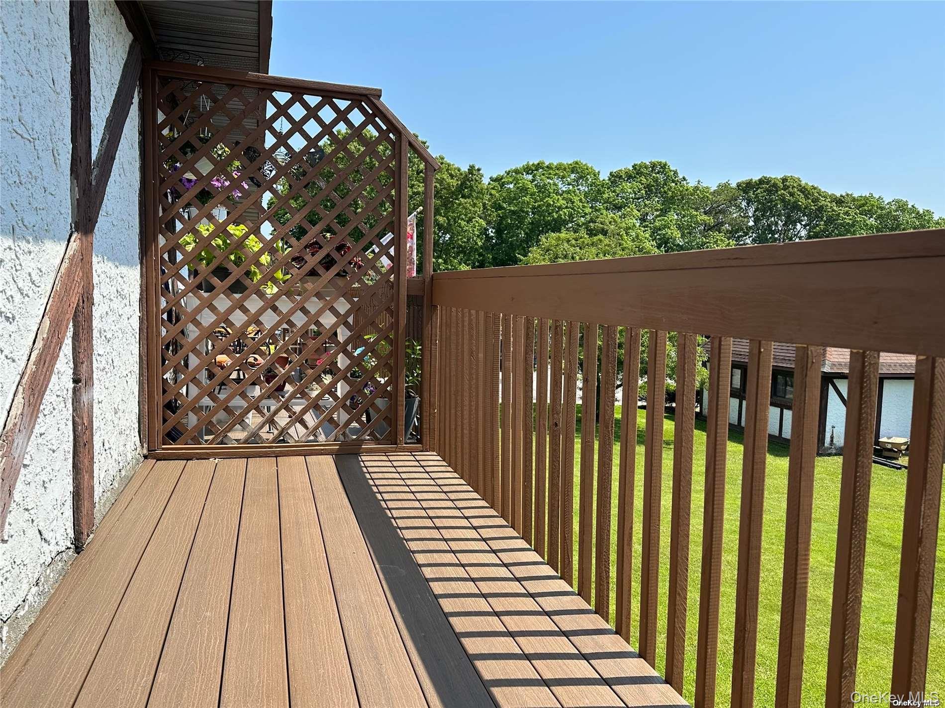 26 Bailey Court, Unit 26 Middle Island, NY 11953 - Photo 10 of 16 a view of a balcony with wooden floor