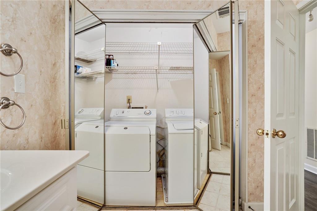 3203 Lenox Road Northeast, Unit 6 Atlanta, GA 30324 - Photo 18 of 27 a bathroom with a shower sink and mirror