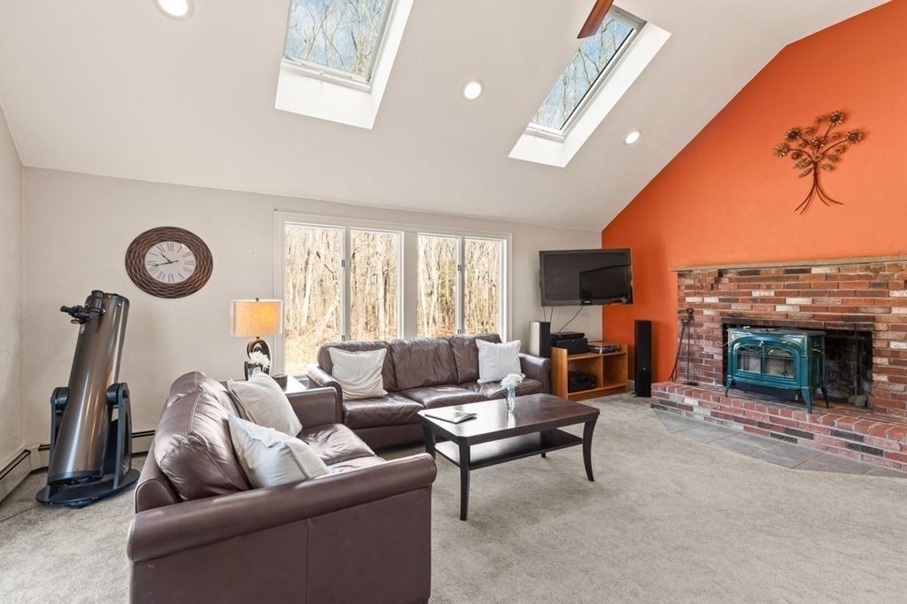 166 Edge Hill Road Sharon, MA 02067 - Photo 12 of 34 a living room with furniture a fireplace and a large window
