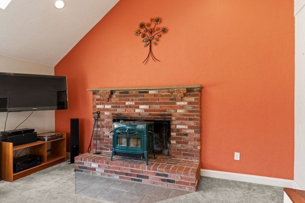 166 Edge Hill Road Sharon, MA 02067 - Photo 13 of 34 a living room with furniture a flat screen tv and a fireplace