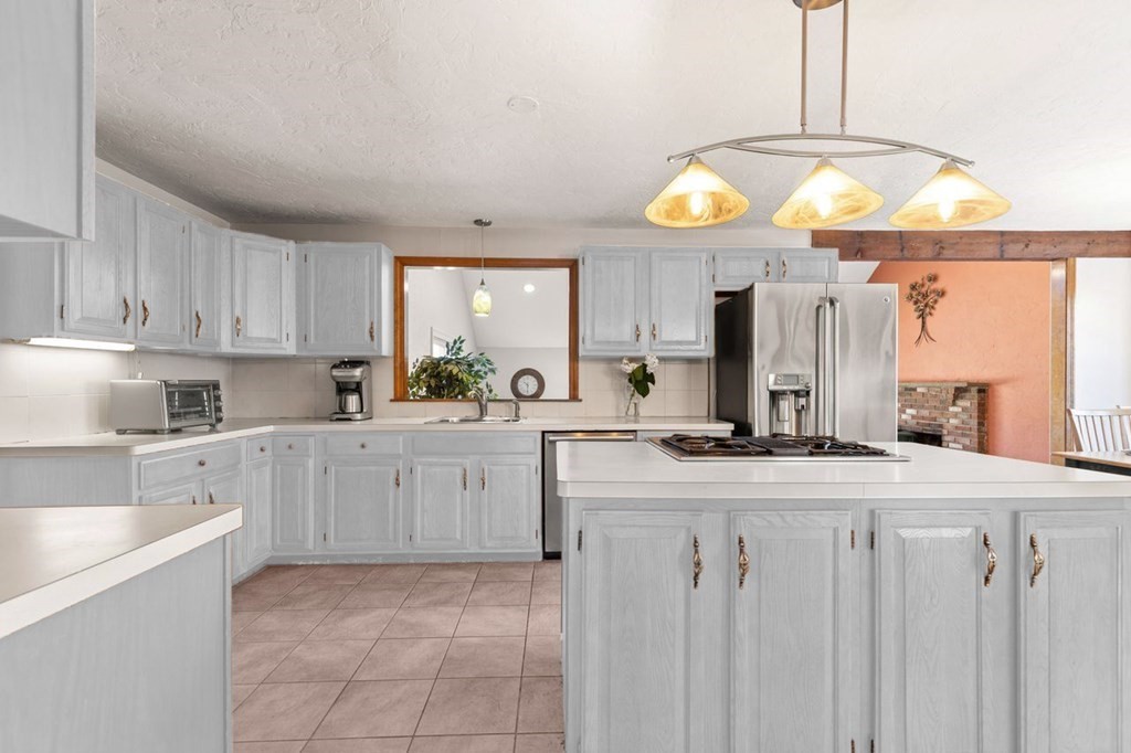166 Edge Hill Road Sharon, MA 02067 - Photo 16 of 34 a kitchen with cabinets and chairs