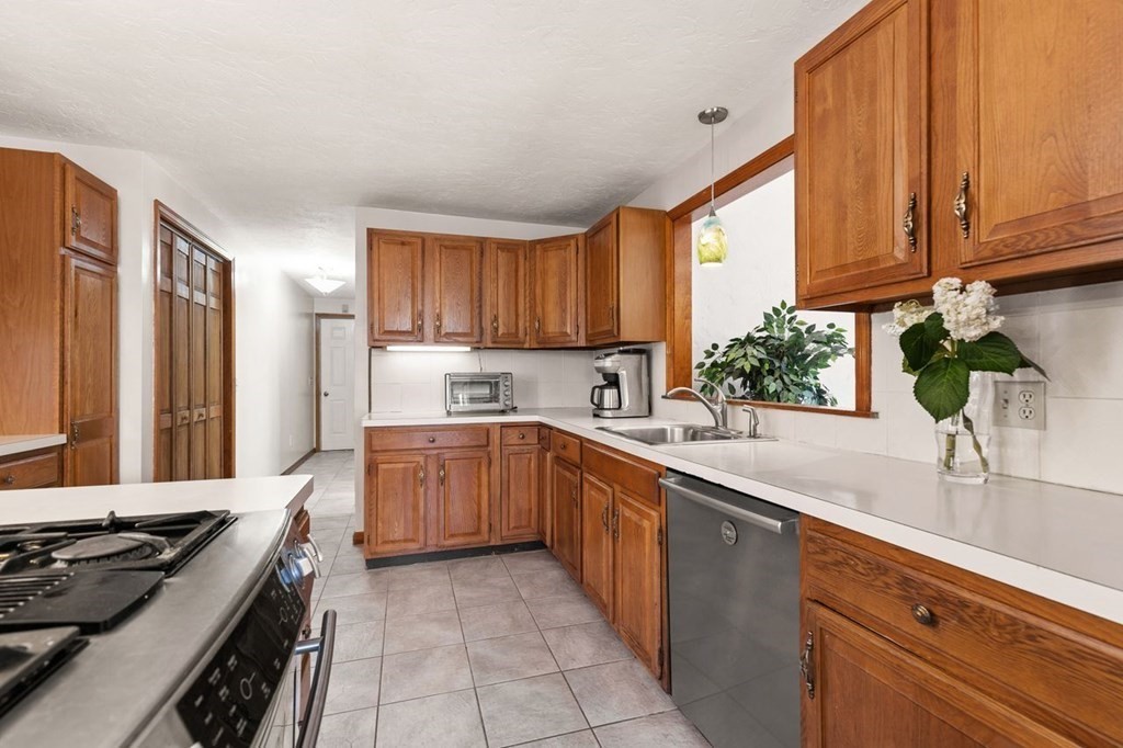 166 Edge Hill Road Sharon, MA 02067 - Photo 20 of 34 a kitchen with stainless steel appliances granite countertop a stove sink and cabinets
