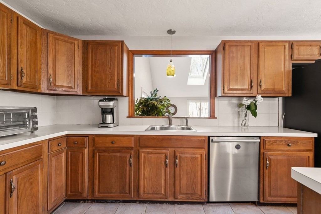 166 Edge Hill Road Sharon, MA 02067 - Photo 21 of 34 a kitchen with stainless steel appliances granite countertop wooden cabinets a sink and dishwasher with wooden floor