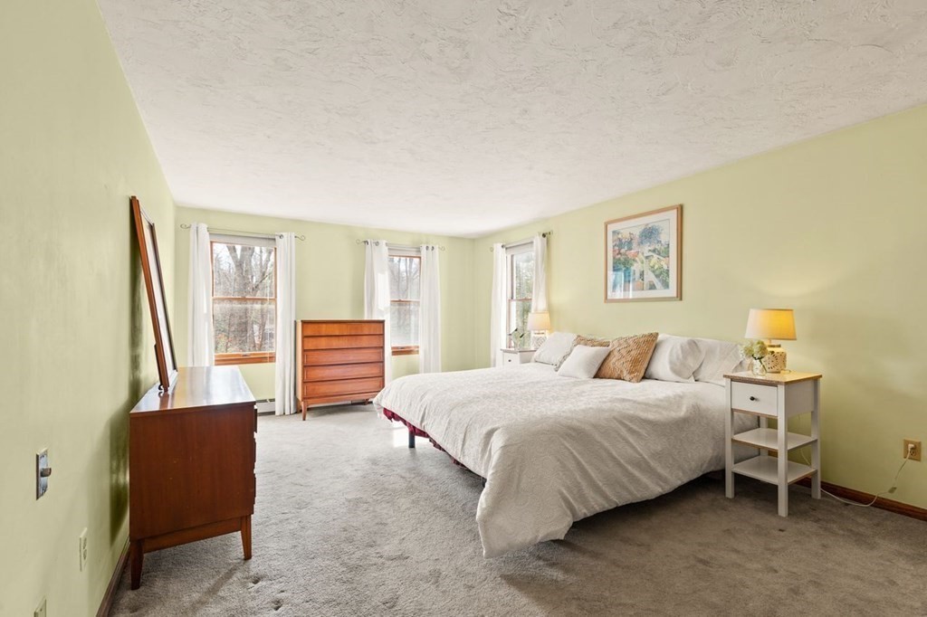 166 Edge Hill Road Sharon, MA 02067 - Photo 26 of 34 a bedroom with a bed and a couch next to a window