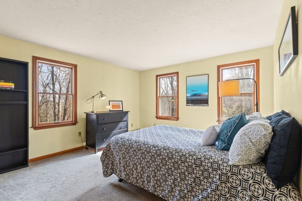 166 Edge Hill Road Sharon, MA 02067 - Photo 28 of 34 a bedroom with a bed and a window with chair