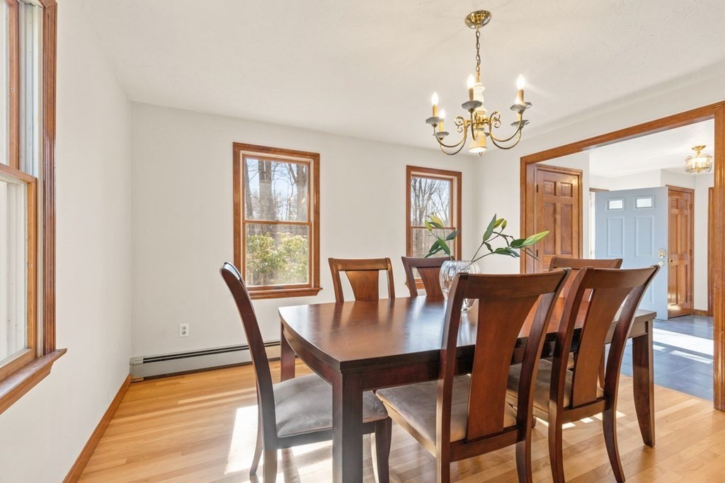 166 Edge Hill Road Sharon, MA 02067 - Photo 5 of 34 a view of a dining room with furniture a chandelier and wooden floor