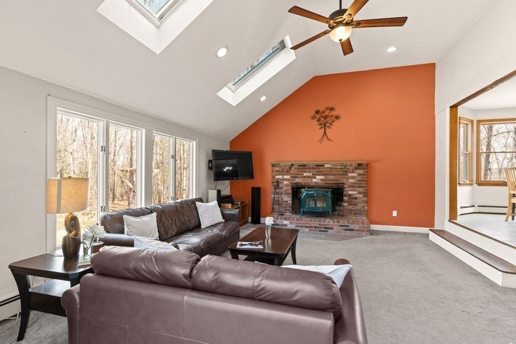 166 Edge Hill Road Sharon, MA 02067 - Photo 10 of 34 a living room with furniture a fireplace and a large window