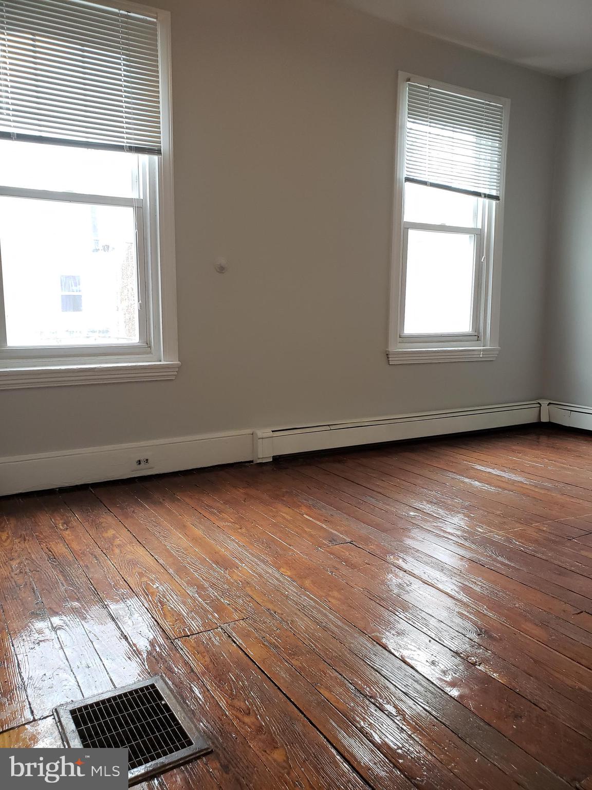 1623 Webster Street Philadelphia, PA 19146 - Photo 24 of 36 an empty room with wooden floor and windows