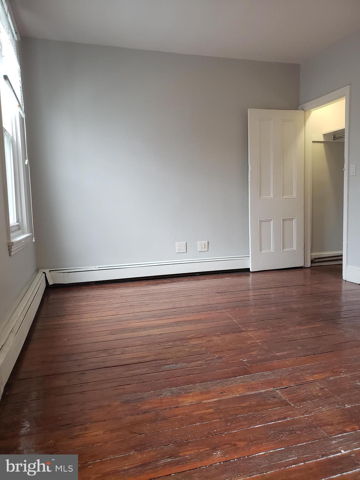 1623 Webster Street Philadelphia, PA 19146 - Photo 25 of 36 a view of an empty room with wooden floor and a window