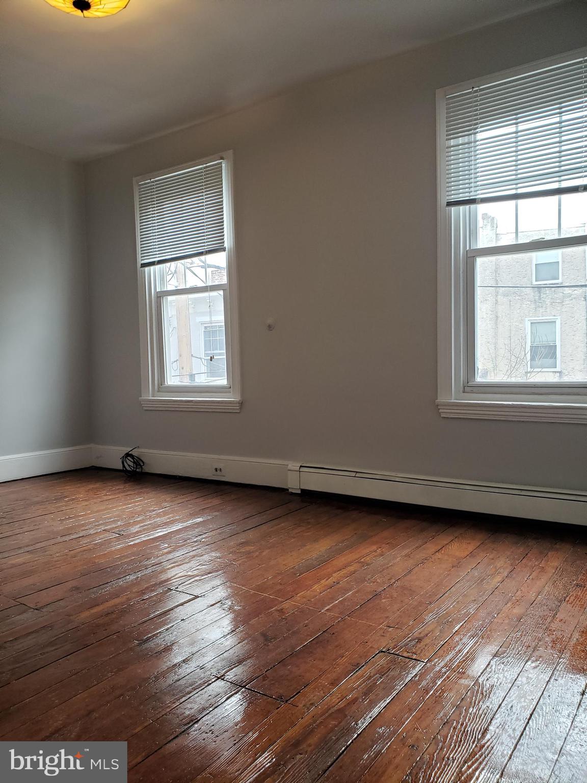 1623 Webster Street Philadelphia, PA 19146 - Photo 27 of 36 an empty room with wooden floor and windows