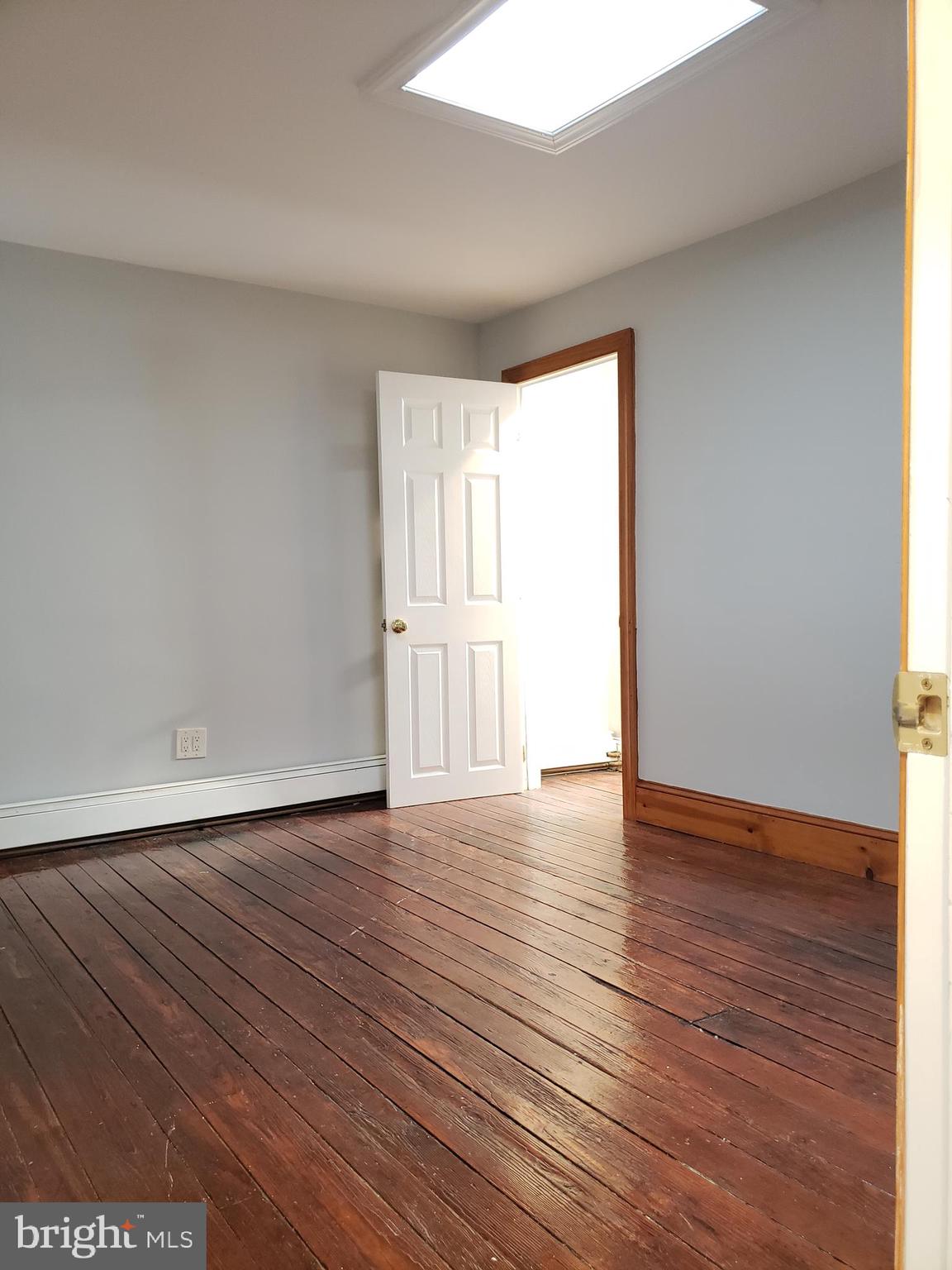 1623 Webster Street Philadelphia, PA 19146 - Photo 32 of 36 a view of an empty room with wooden floor and a window