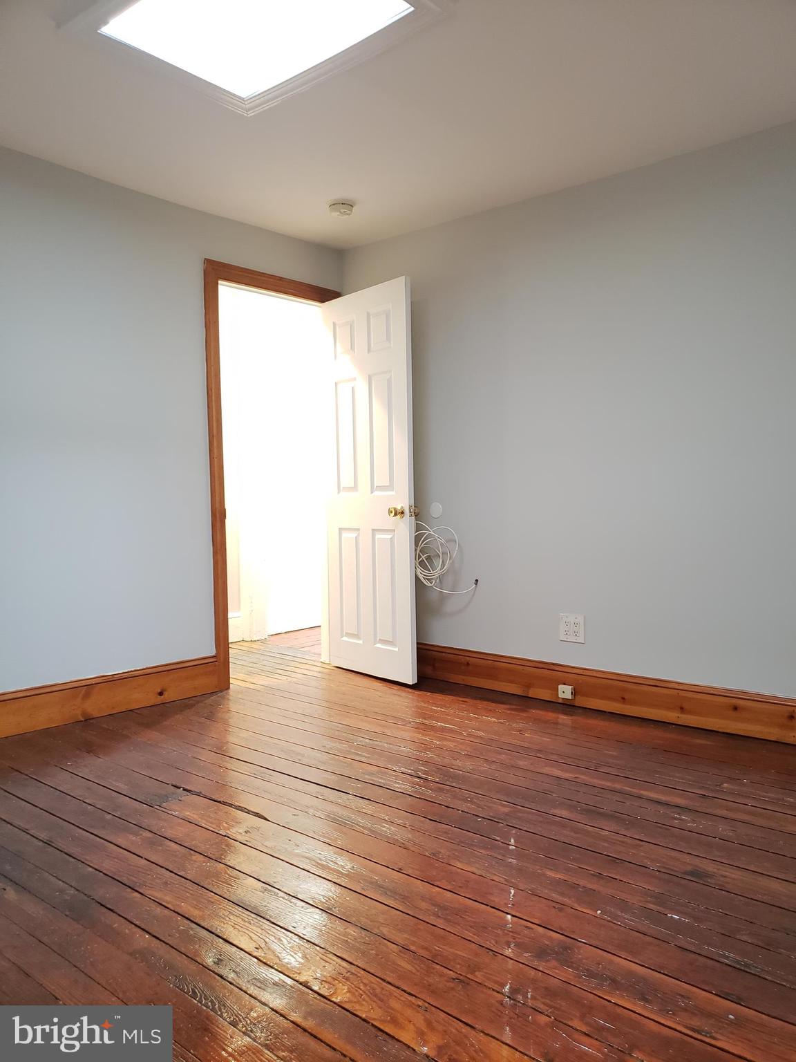 1623 Webster Street Philadelphia, PA 19146 - Photo 34 of 36 a view of an empty room with wooden floor and a window