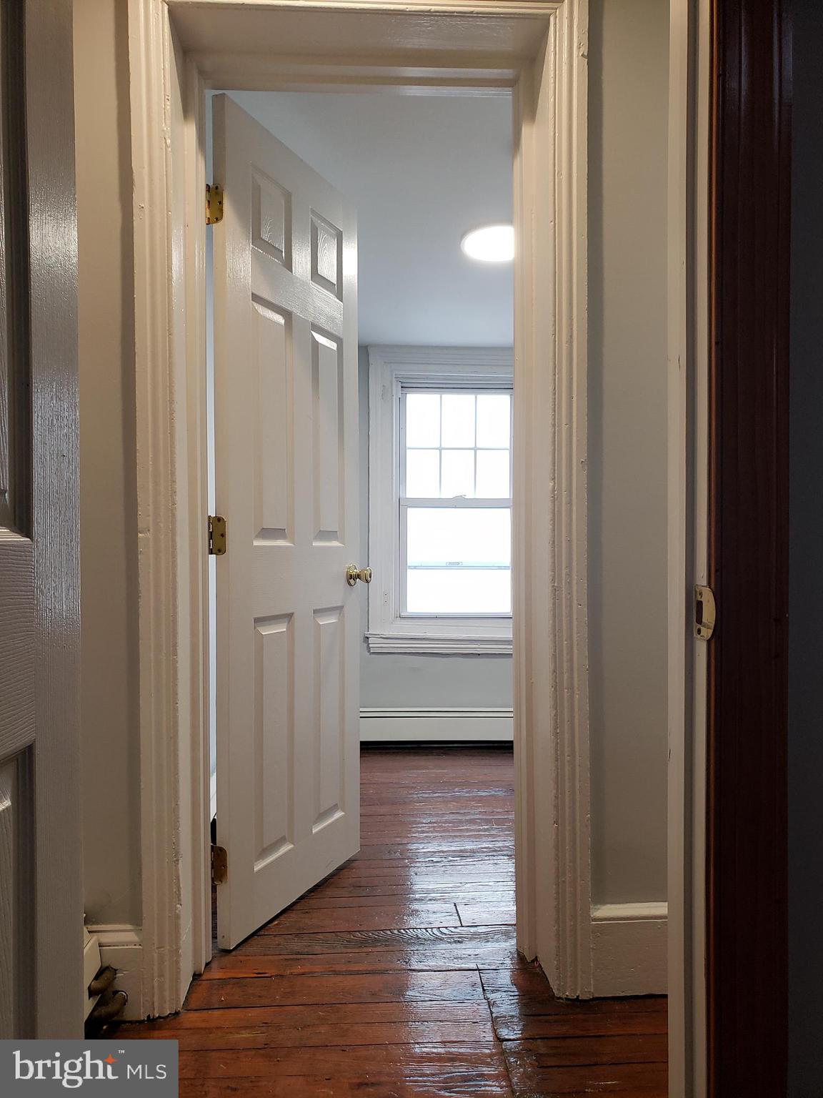 1623 Webster Street Philadelphia, PA 19146 - Photo 35 of 36 a view of an empty room with wooden floor and a window
