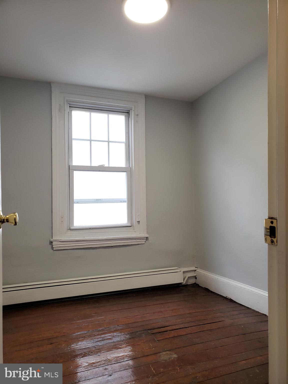 1623 Webster Street Philadelphia, PA 19146 - Photo 36 of 36 a view of an empty room with wooden floor and a window