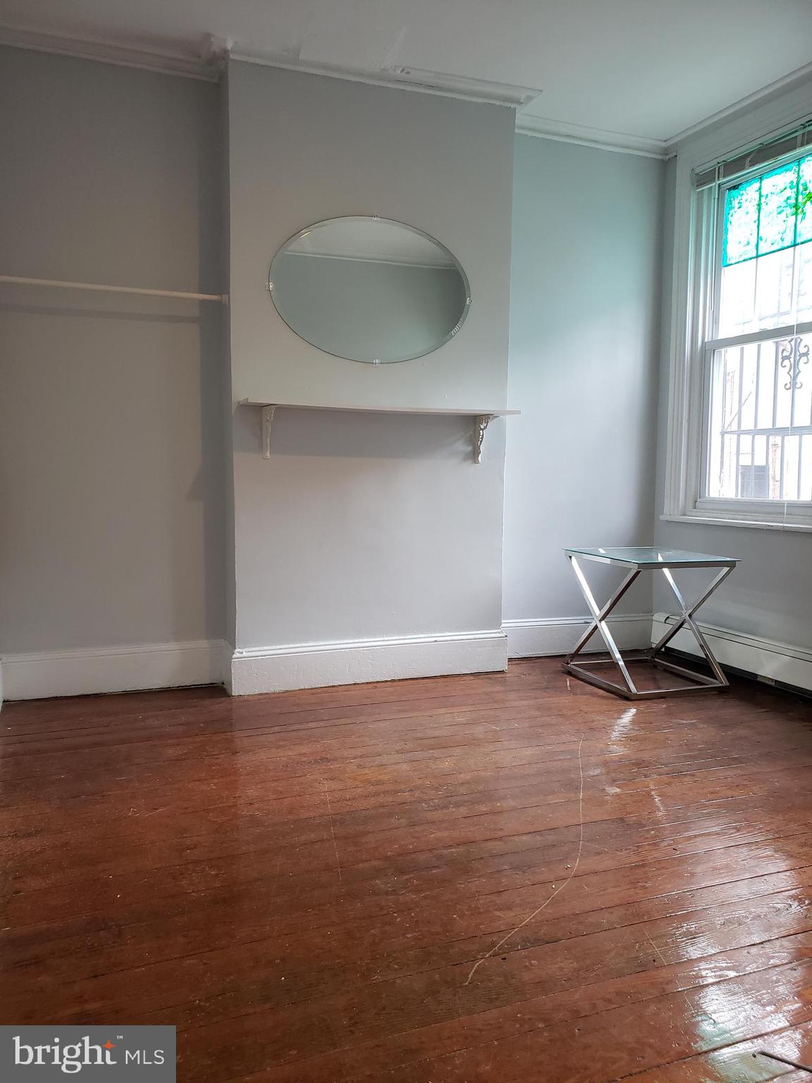 1623 Webster Street Philadelphia, PA 19146 - Photo 4 of 36 an empty room with wooden floor and a window
