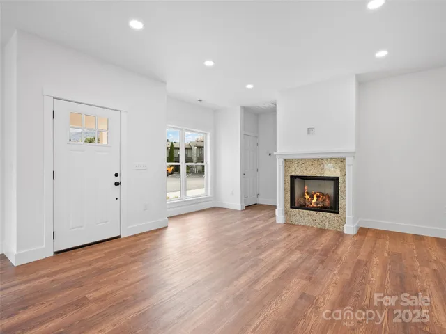 a view of a kitchen with a microwave and wooden floor