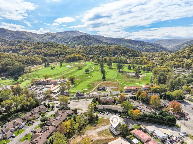 an aerial view of residential houses with outdoor space and street view