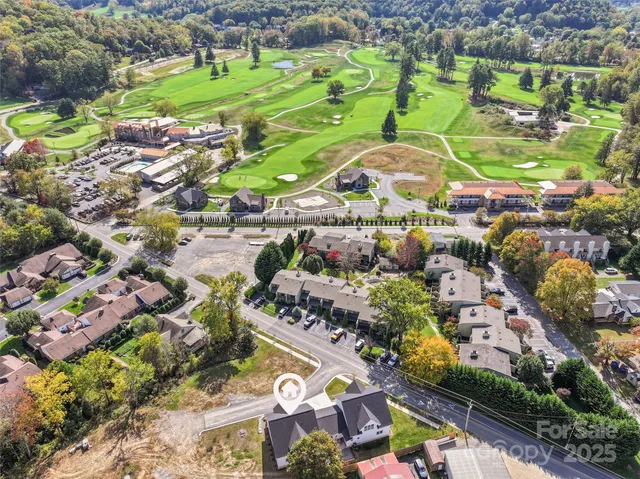 a view of house with swimming pool and trees in the background