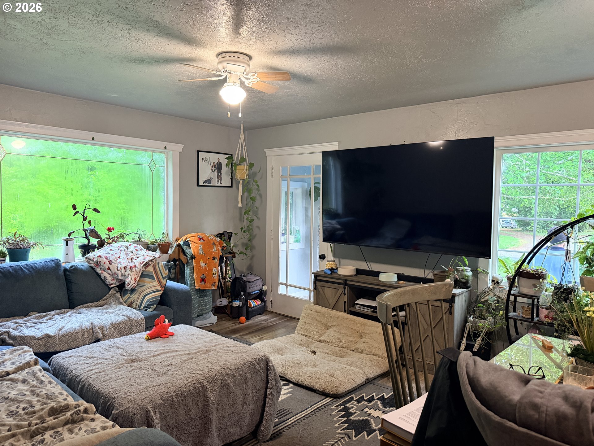 677 Southeast Moffitt Road Waldport, OR 97394 - Photo 22 of 36 a living room with furniture and a flat screen tv