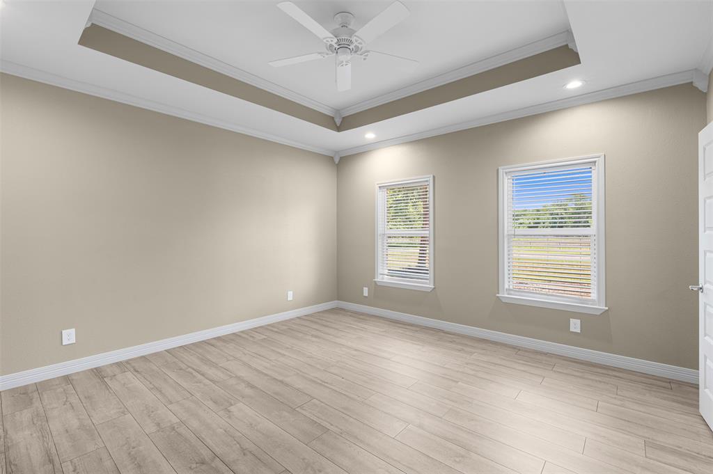 1011 Southeast County Road Corsicana, TX 75109 - Photo 15 of 40 a view of an empty room with wooden floor and a window