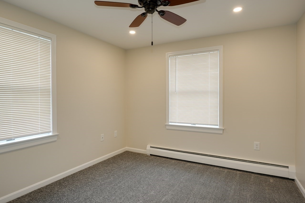 49 Douglas Avenue, Unit 49 Maynard, MA 01754 - Photo 14 of 23 an empty room with a window and a fan