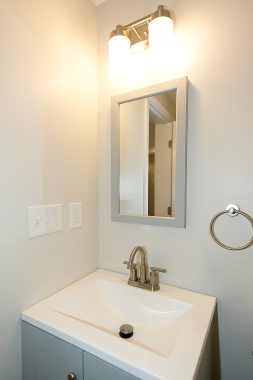 49 Douglas Avenue, Unit 49 Maynard, MA 01754 - Photo 15 of 23 a bathroom with a sink vanity and mirror